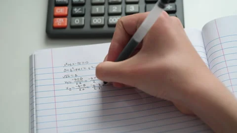 A student doing math in a notebook. Stock Footage 307139444