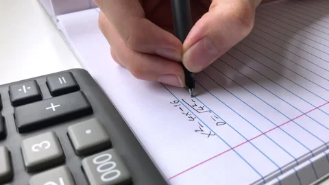 A student doing math in a notebook. Stock Footage 311200959