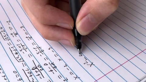 A student doing math in a notebook. Stock Footage 313681769