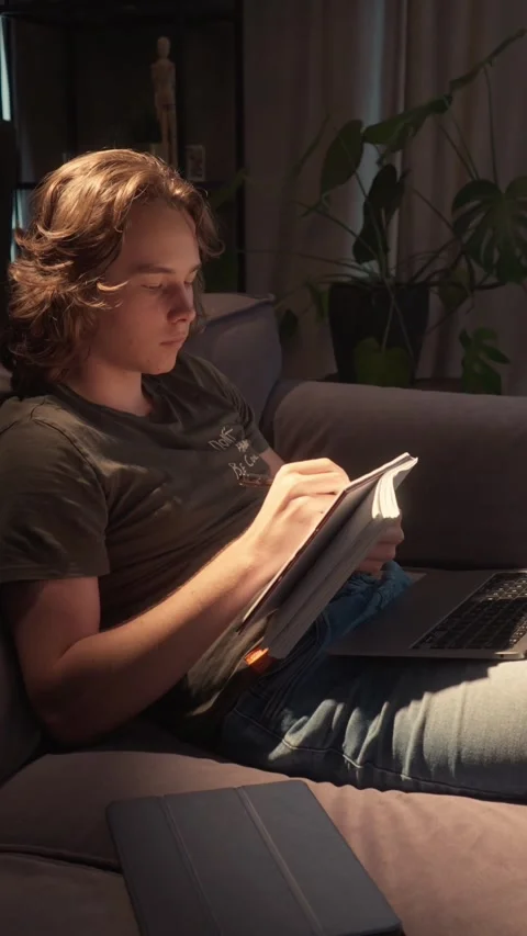 Student doing research late at night, gathering information for a paper Stock Footage 310739298