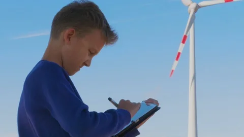 Student drawing windmill on tablet, alternative education Stock Footage 117367044