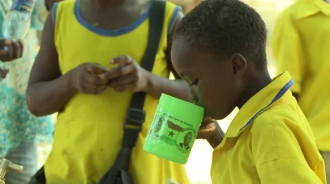 STUDENT DRINKS WATER FROM CUP THEN PASSES CUP TO ANOTHER STUDENT Stock Footage 59865218