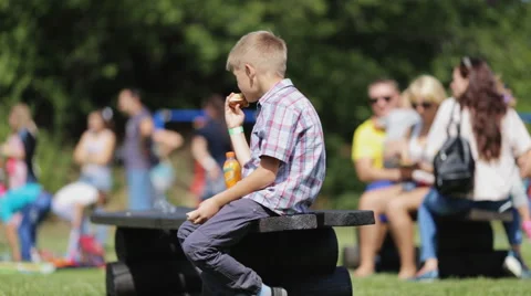 Student eats breakfast in the schoolyard Video stock 54670645