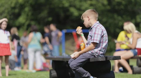 Student eats breakfast in the schoolyard Stock Footage 54671054