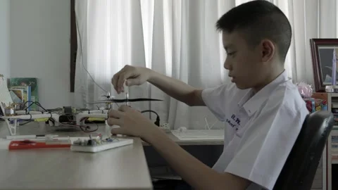Student Engaged in Electronics Project at Home Stock Footage 318863407