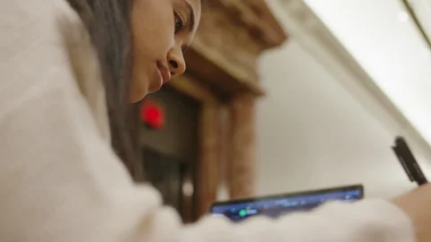Student engaged in focused writing study session at library Stock Footage 312769610