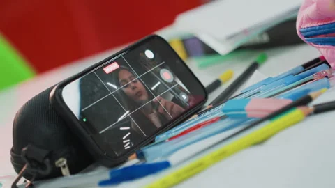 Student engaged remotely. Casual study environment with vibrant stationery items Vídeo Stock 328156646