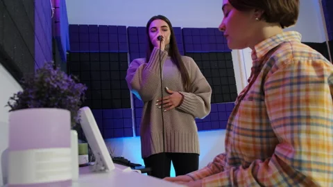 Student engages in collaborative vocal session with instructor Stock Footage 307019838