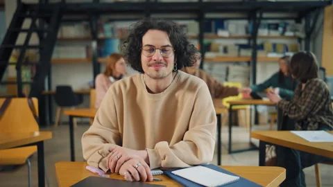 Student engages in study session at library with peers collaborating on group pr Stock Footage 337324584