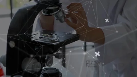 Student entering right, grasping scope, focusing, studying slide in lab with Stock Footage 331235954