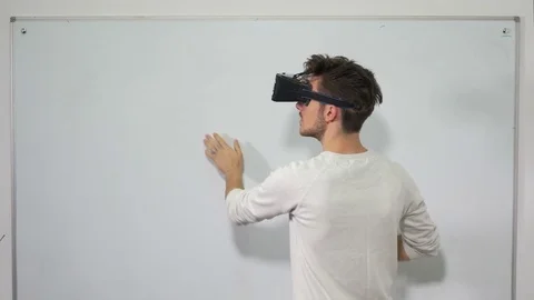 Student entering virtual reality world with VR glasses and using interactiv.. Stock Footage 71468768
