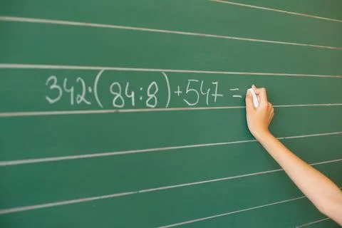 Student erases chalkboard in classroom while preparing for new lessons and .. Stock Photos
