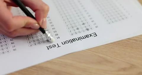 Student erases wrong answer on exam form with light eraser Stock Footage 264116036