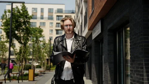 The student examines the folder with documents. Bottom angle, slow motion. The Stock Footage 247387385