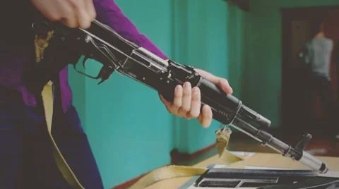 Student examines the weapon Kalashnikov Stock Footage 62925400