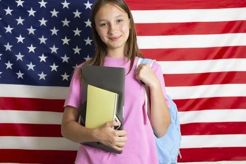 Student exchange program in the USA, girl studying in front of American flag Stock-Fotos