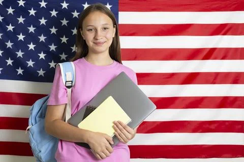 Student exchange program in the USA, girl studying in front of American flag Stock-Fotos