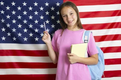 Student exchange program in the USA, girl studying in front of American flag Stock-Fotos