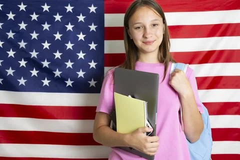 Student exchange program in the USA, girl studying in front of American flag Stock-Fotos