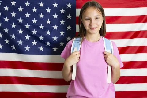 Student exchange program in the USA, girl studying in front of American flag Stock-Fotos
