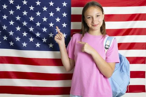 Student exchange program in the USA, girl studying in front of American flag Stock-Fotos