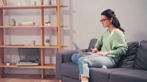 Student in eyeglasses using laptop during e-learning at home Stock Footage 144822335