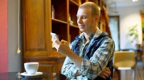 Student finish talking on cellphone and smiling to the camera in the library Stock Footage 67541598