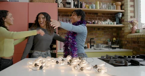 Student Friends Hugging whilst Decorating their Apartment for Christmas Stock Footage 297279905