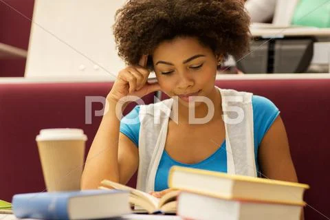 Student girl with books and coffee on lecture Stock Photos