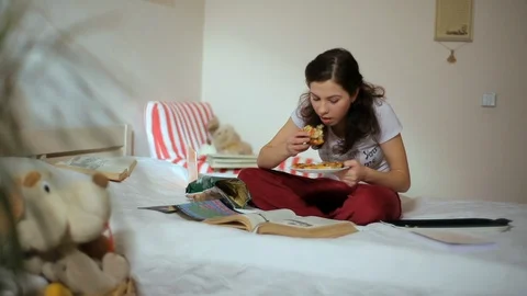 Student girl eats pizza Stock Footage 99807424