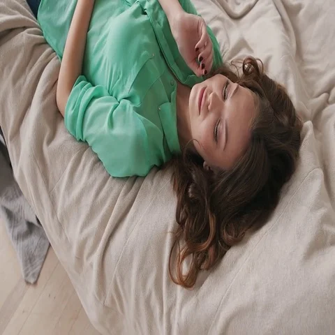Student girl lying on a soft bed Stock Footage 69545816