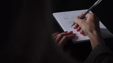 A student girl makes notes with a pen in a Notepad. Stock Footage 144349968