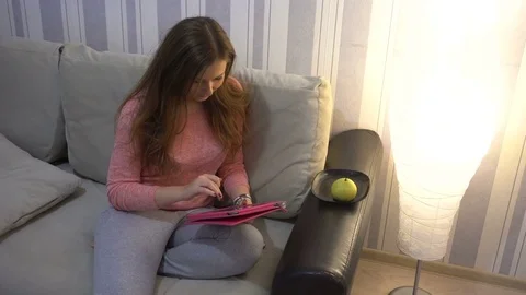 Student girl with tablet pc on the sofa. Stock Footage 72043791
