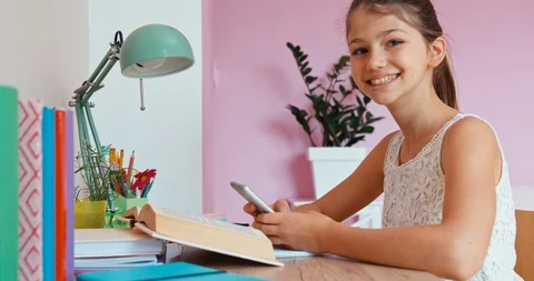 Student girl using cellphone at the table Stock Footage 95440889