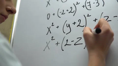 Student girl writing math equal on whiteboard. Math algebra lesson, education Stock Footage 145310409