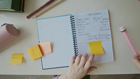 Student Girl Writing Math Lesson Notes on Sticky Note in Notebook Stock Footage 340549363