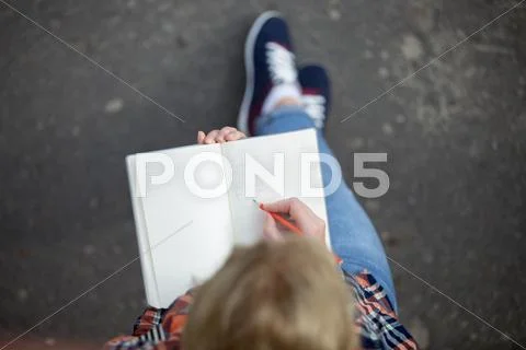 Student girl writing with a pencil in a notebook Stock Photos