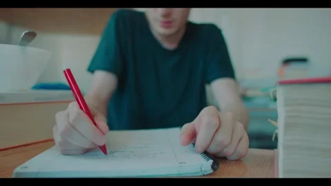 Student Gives up on Doing Homework and starts playing on smartphone Video stock 341858984
