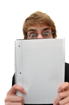Student with glasses holding blank empty spiral notebook isolated on white ba Stock Photos
