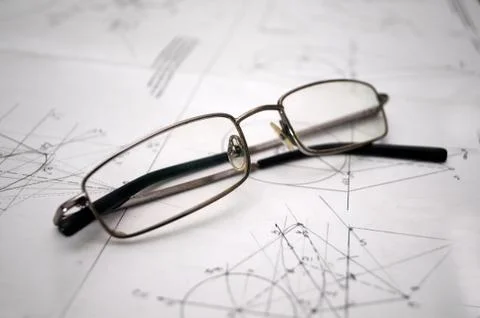 Student glasses left on plans for construction Stock Photos