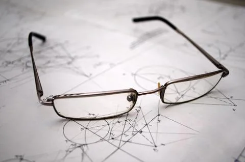 Student glasses left on plans for construction Stock Photos