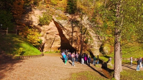 Student Group Exploring Gutman Cave in Sigulda During Golden Autumn Tour Stock Footage 339028515