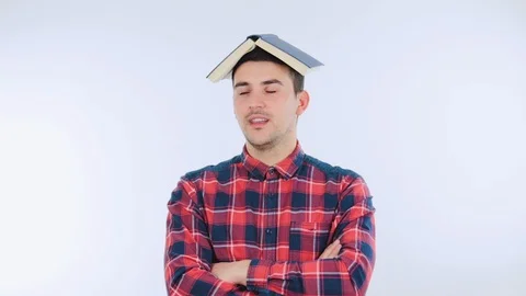 Student guy with book on his head Stock Footage 105925825