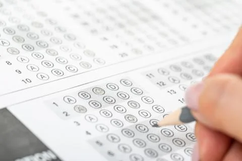 Student hand test in exercise and passing examination paper computer workshee Stock Photos