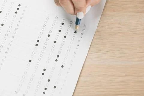 Student hand testing in exercise and passing exam carbon paper computer sheet Foto stock