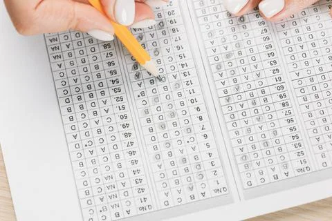 Student hand testing in exercise and passing exam carbon paper computer sheet Stock Photos