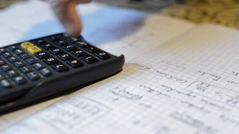 Student hand using calculator and pencil for math study. Vídeo Stock 221327624