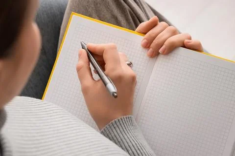 Student hand writing notes in grid notebook with pen, education and learning  Stock Photos