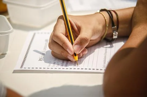 Student hand writing notes on questionnaire for education Stock Photos