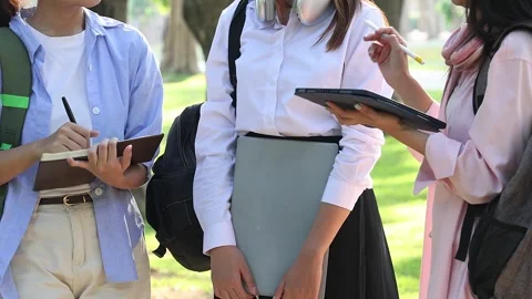 Student hands collaborate, holding a notebook and tablet modern education. Stock Footage 311879357